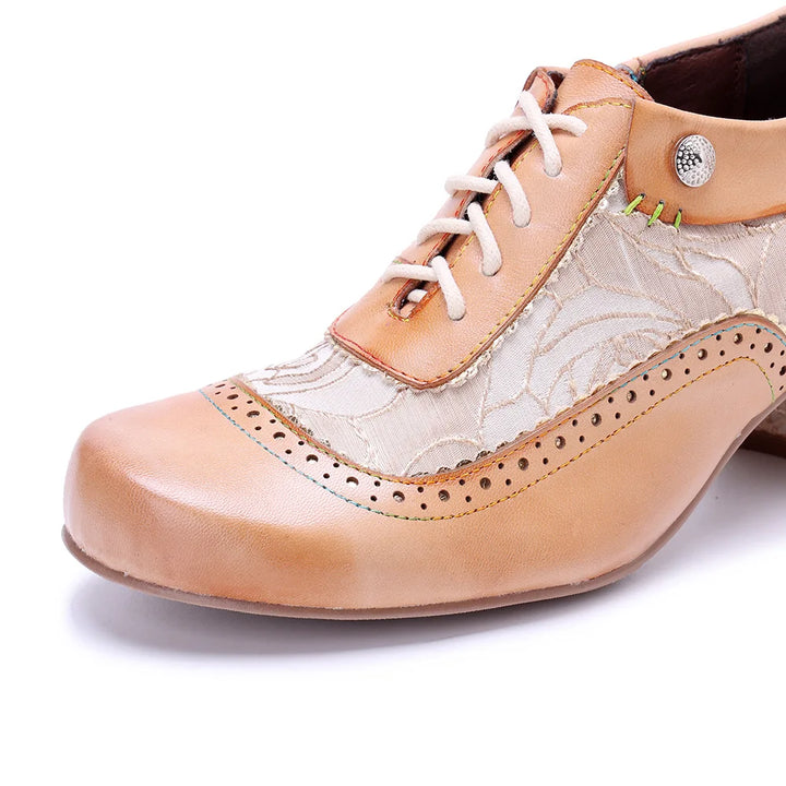 Women’s lace-up heel shoe close-up, light khaki-beige toe with white patterned vamp