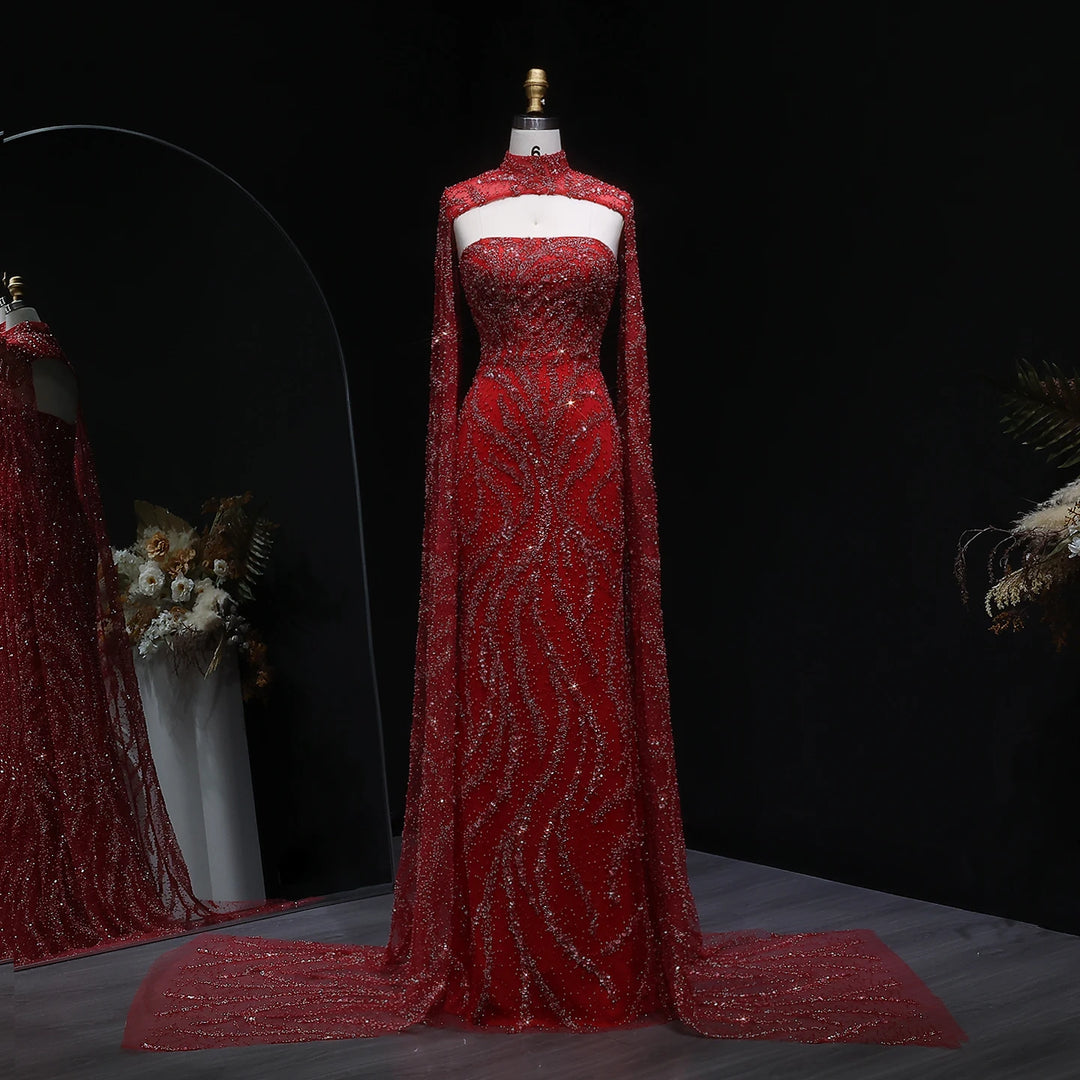 Red evening gown with cape on a mannequin against a dark background