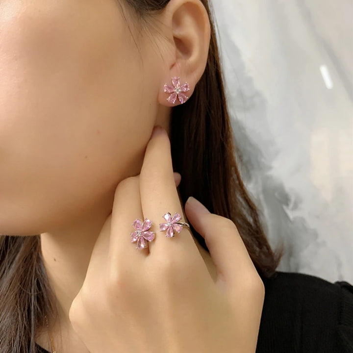 Pink flower stud earring on model with six teardrop stones and silver-tone prongs
