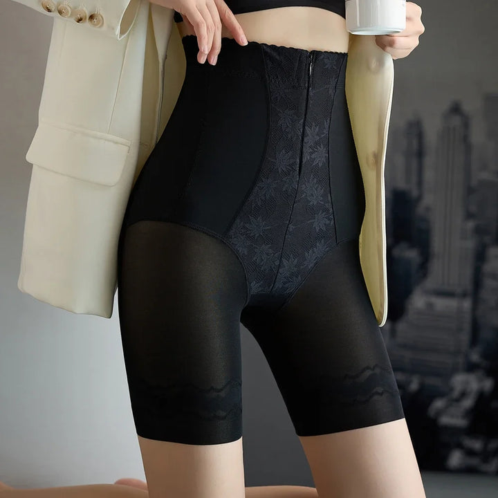 Black high-waist compression shorts with textured front panel and sheer leg sections