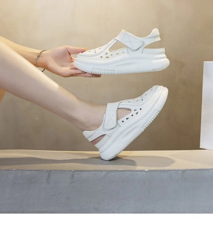 White thick-sole leather sandals with perforated vamp and adjustable hook-and-loop strap.