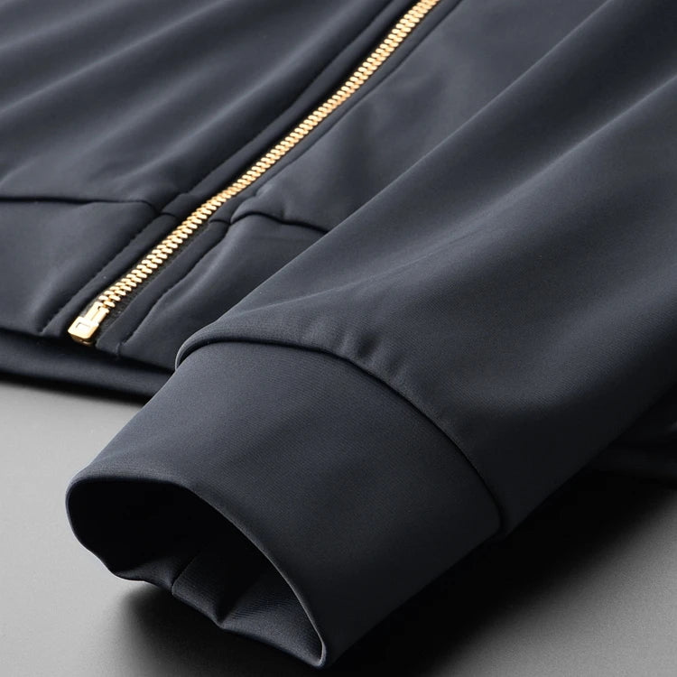 Navy hoodie sleeve cuff with gold zipper detail and stitched seam