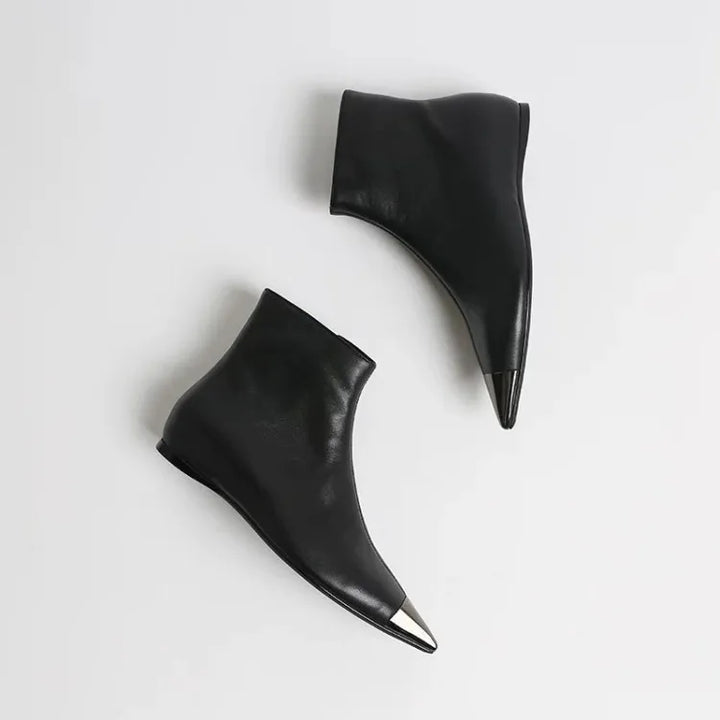Black pointed-toe ankle heel boots, pair shown from above with slim pointed heel.