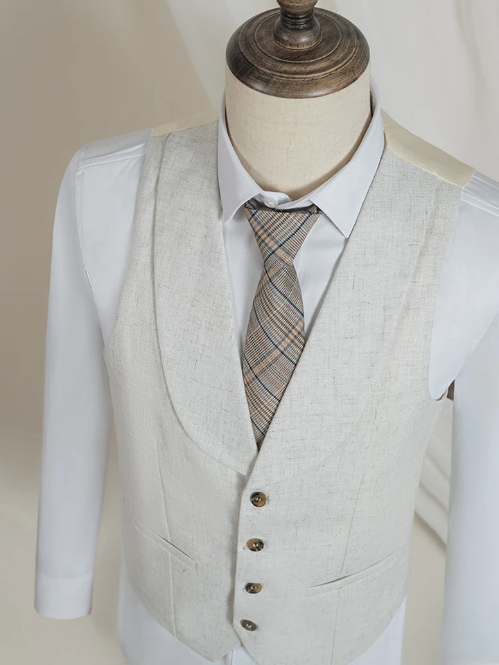 Light beige suit vest on mannequin with patterned necktie under jacket