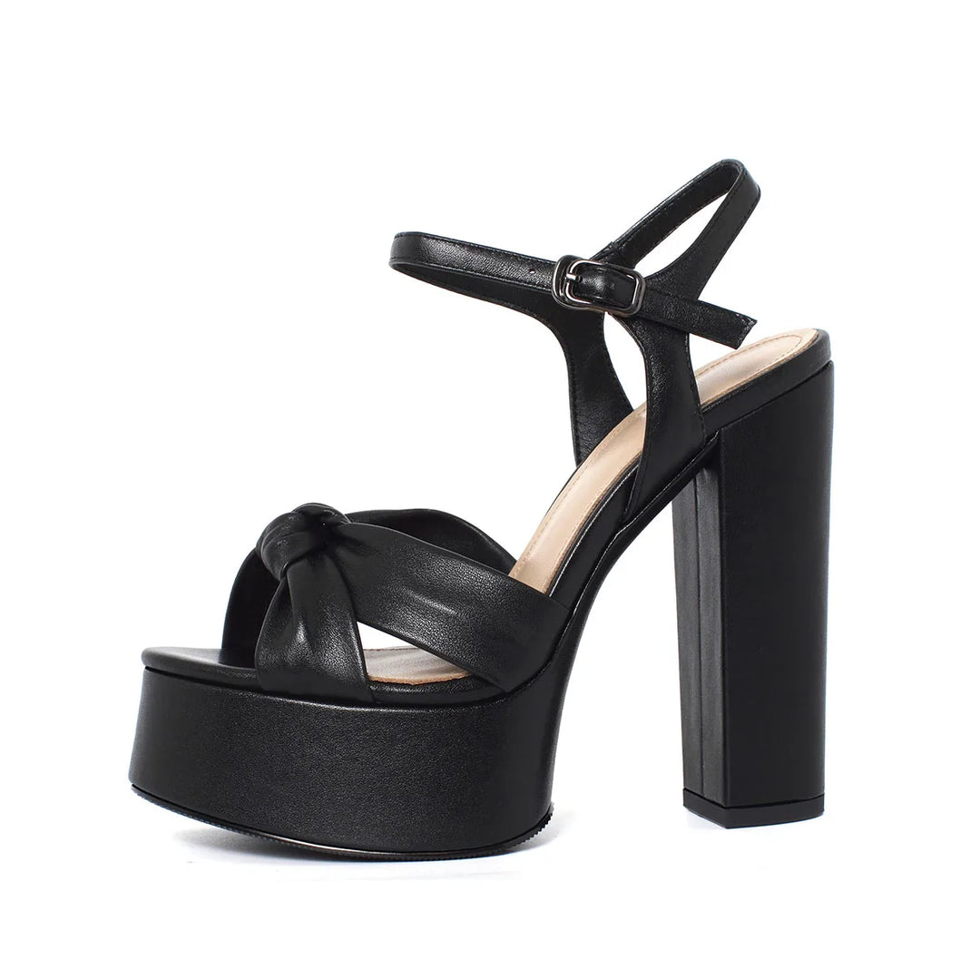 Black platform block-heel sandal with round toe, cross straps, and buckle ankle strap