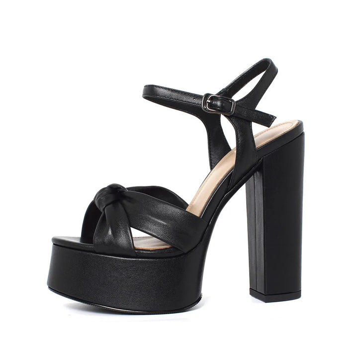 Black platform block-heel sandal with round toe, cross straps, and buckle ankle strap