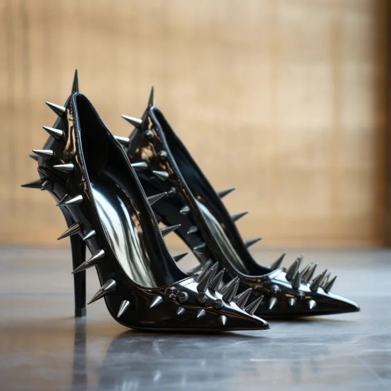 Black patent leather women's spike rivet heel pumps, side view with pointed toe