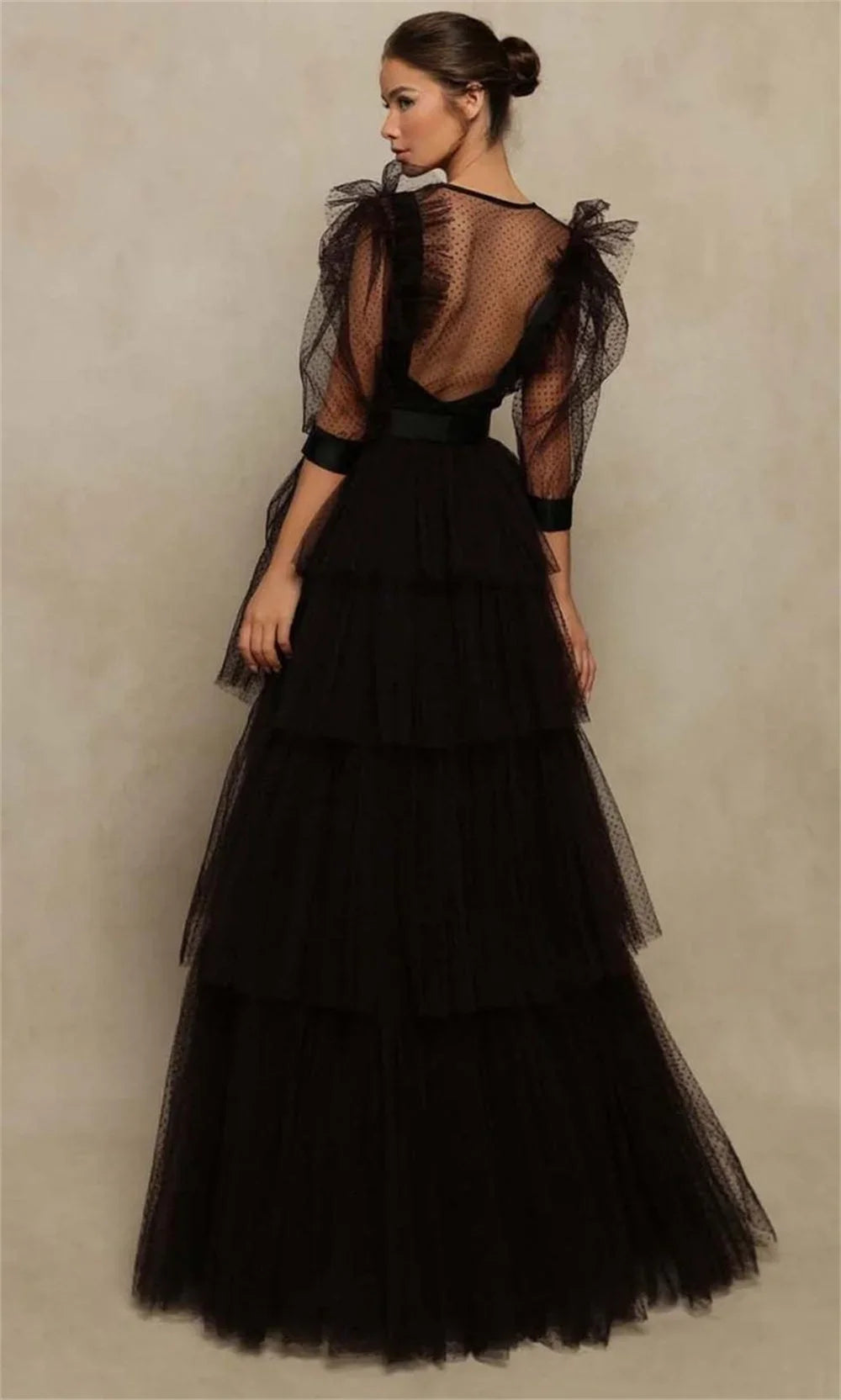 Black tiered ball gown with sheer back and long puff sleeves