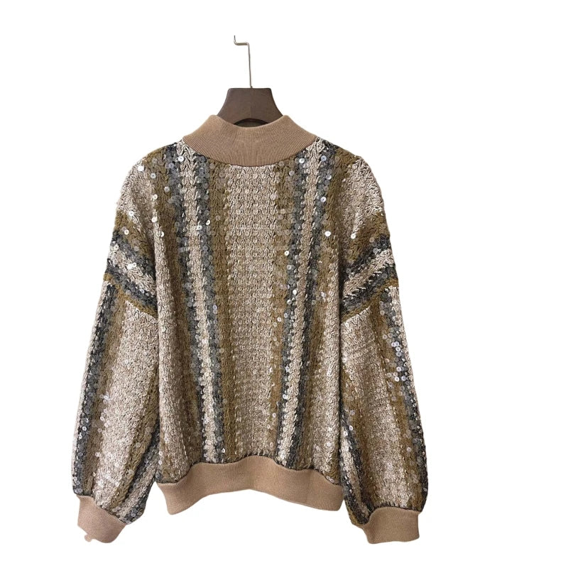 Patterned sweater on a hanger against a white background