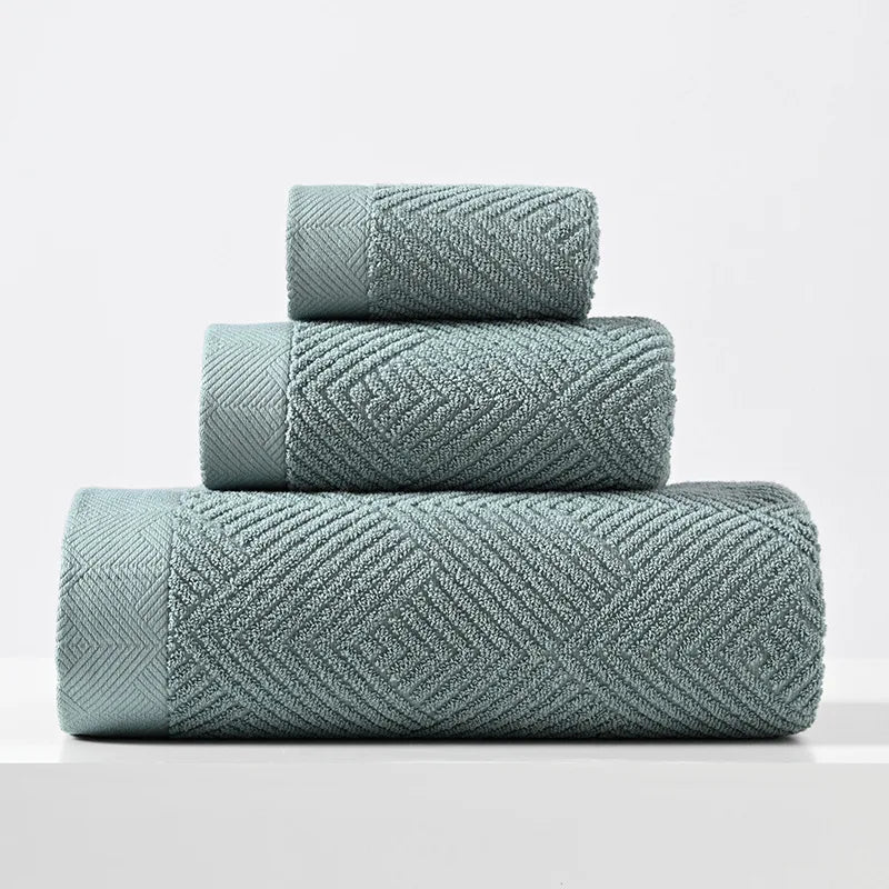Blue-green cotton towel set with thick chevron weave, stacked folded towels