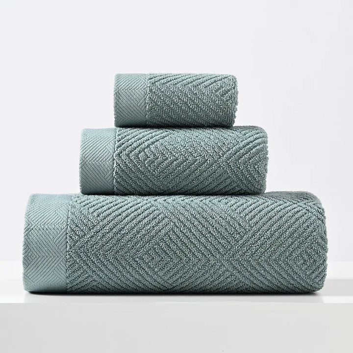 Blue-green cotton towel set with thick chevron weave, stacked folded towels