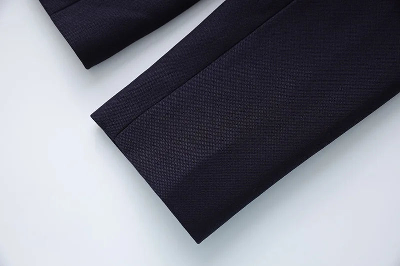 Navy blazer hem and sleeve hem detail on flat lay