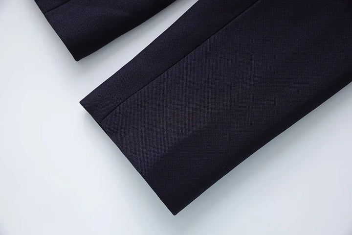Navy blazer hem and sleeve hem detail on flat lay