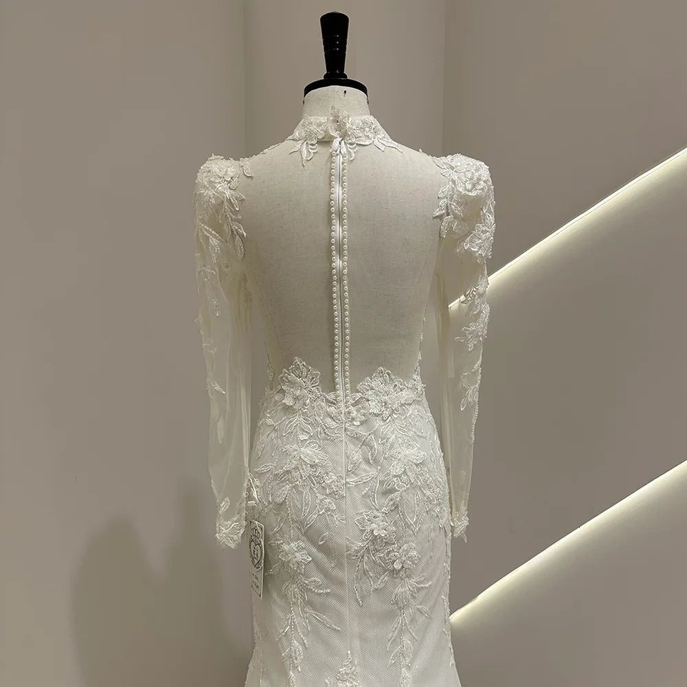 Ivory lace bridal gown back with long sleeves and vertical button trim
