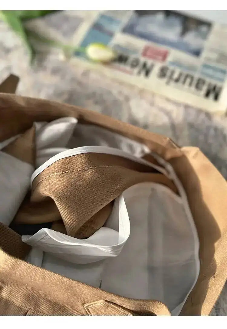 Khaki beige dress pants fabric close-up with folded interior lining.