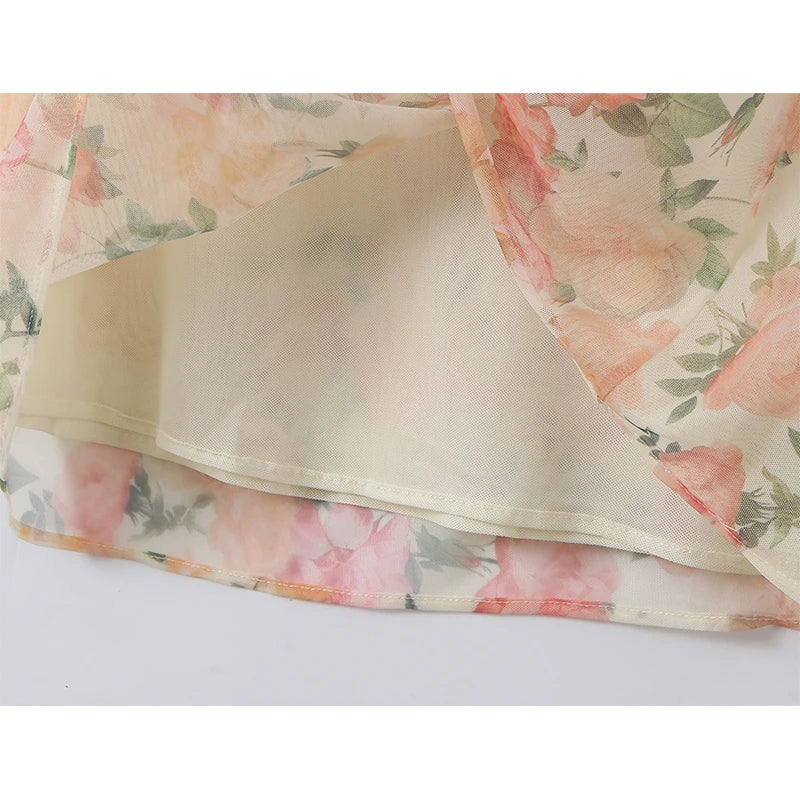 Floral print maxi dress hem with layered underlay and sheer overlay fabric