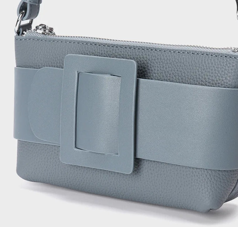 Gray handbag with a decorative buckle on a white background