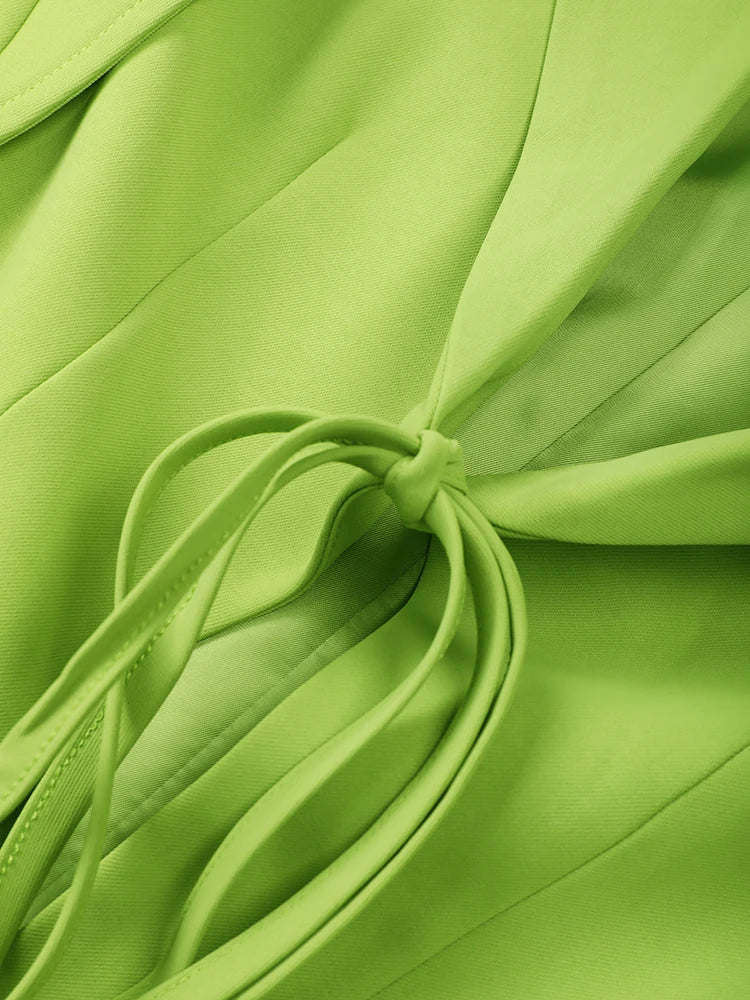 Green blazer fabric detail with stitched seams and lace-up drawcord tie loops