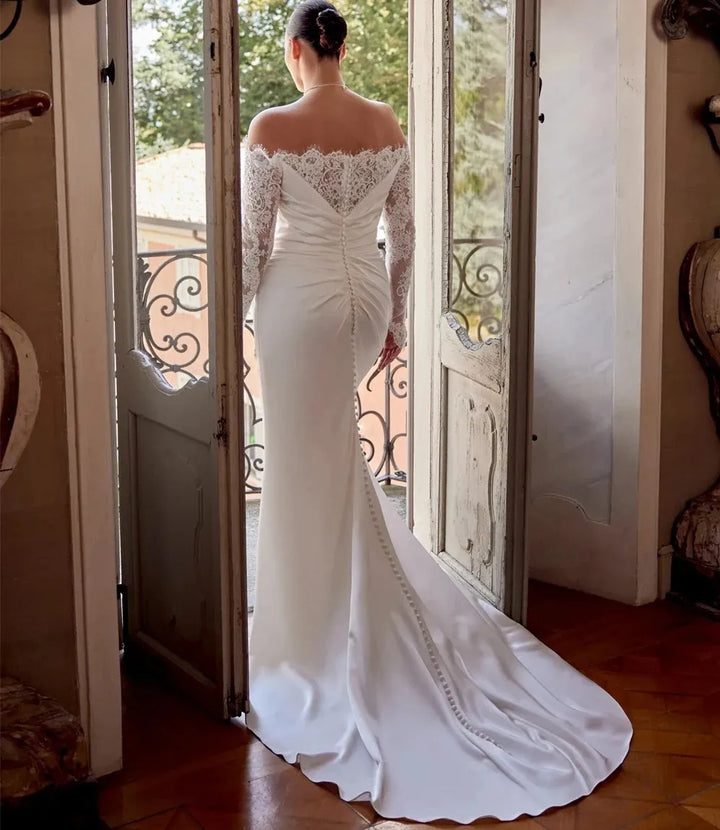 Satin bride gown from back with lace sleeves and long train with side slit