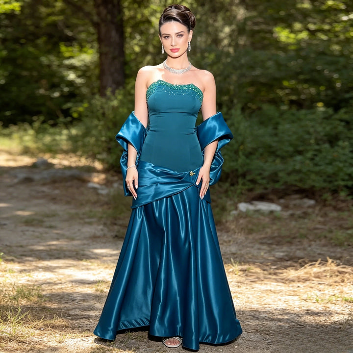 Teal satin strapless ball gown with beaded bodice and draped cape sleeves