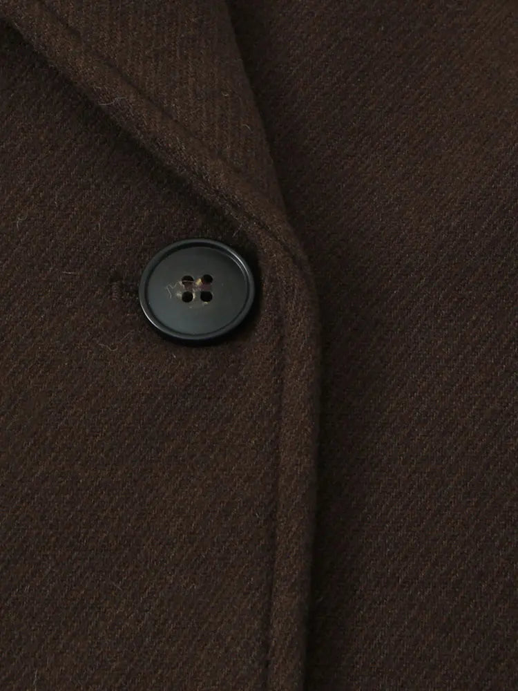 Close-up of dark brown overcoat fabric with round dark buttons
