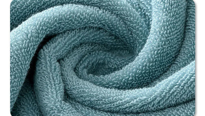 Thick cotton towel set showing beige folded towel and teal textured towel close-up.