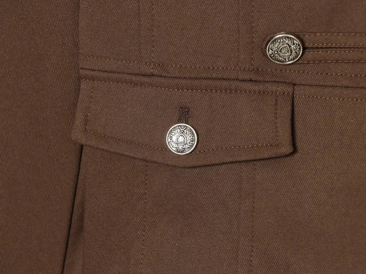 Brown blazer chest pocket with round silver button and visible topstitching