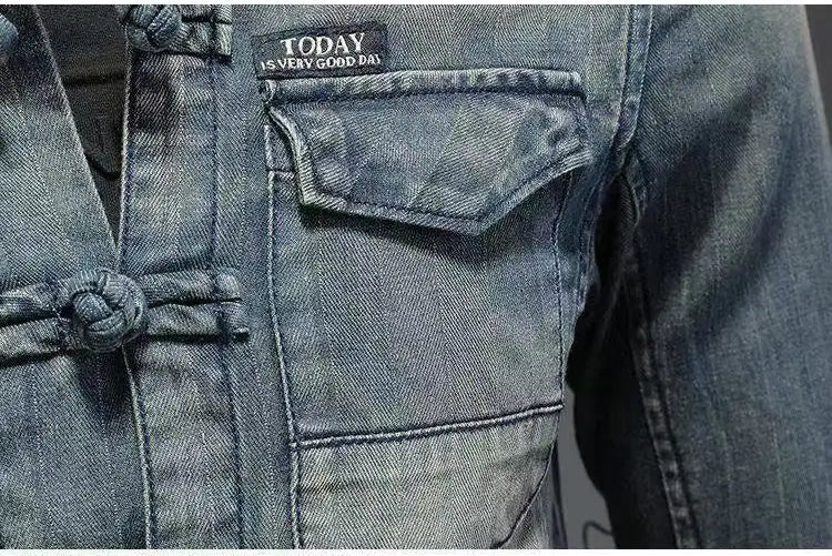 Close-up of men’s light blue denim shirt chest pocket and front button placket