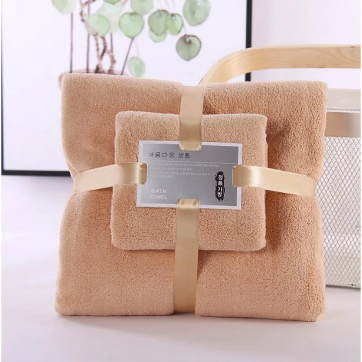Tan/brown plush bath towel set, two folded towels tied with ribbon