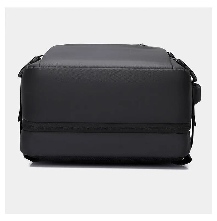 Black travel backpack rear view with lower zip panel and top carry handle