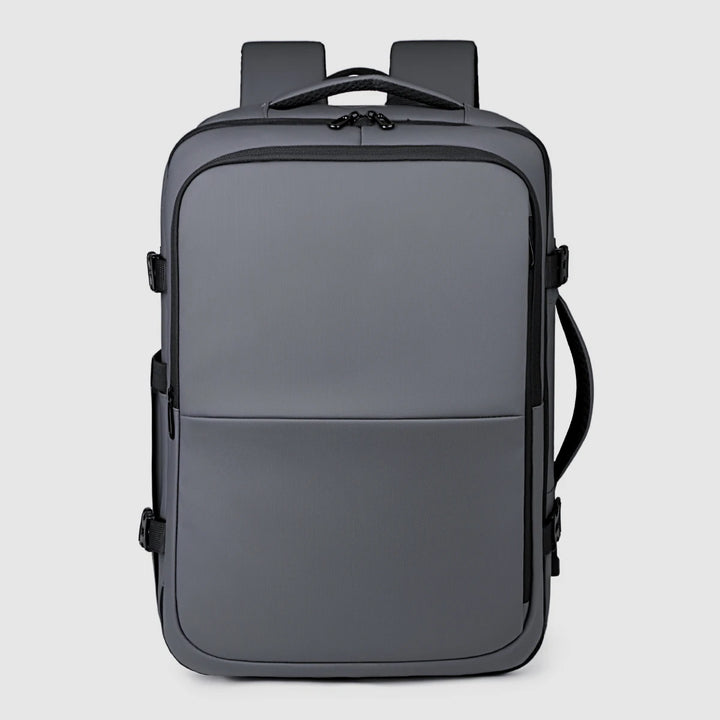 Black backpack back view with top carry handle and adjustable shoulder strap