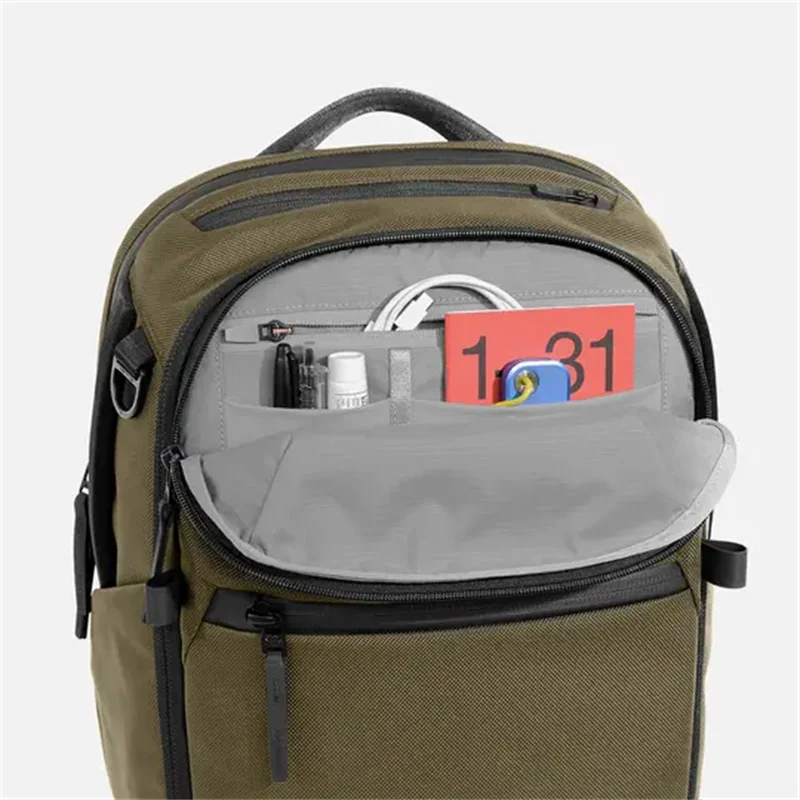 Olive green backpack top organizer pocket with multiple compartments and zip closure