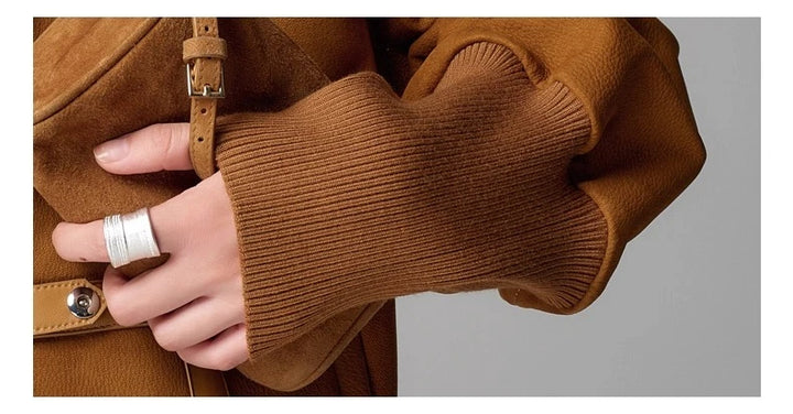 Brown leather jacket sleeve cuff and ribbed knit detail near wrist