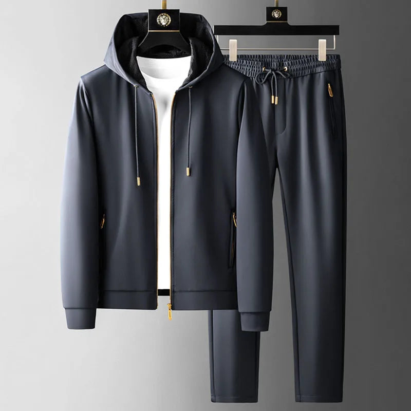 Navy men’s hoodie and jogger pants set with gold accents, shown on hangers