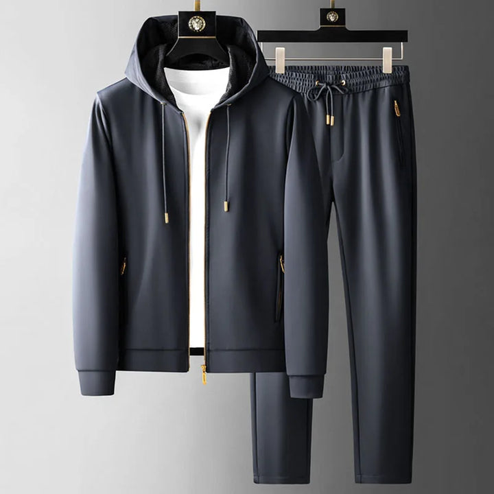 Navy men’s hoodie and jogger pants set with gold accents, shown on hangers