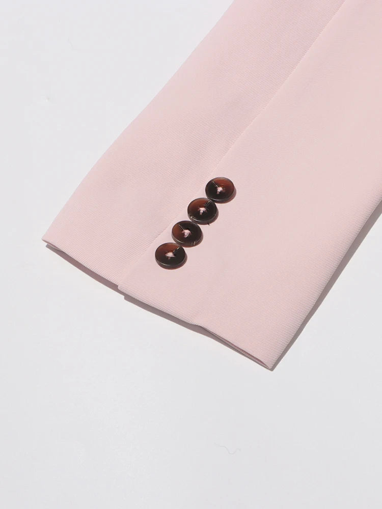 Pink slim blazer sleeve cuff with three dark button accents