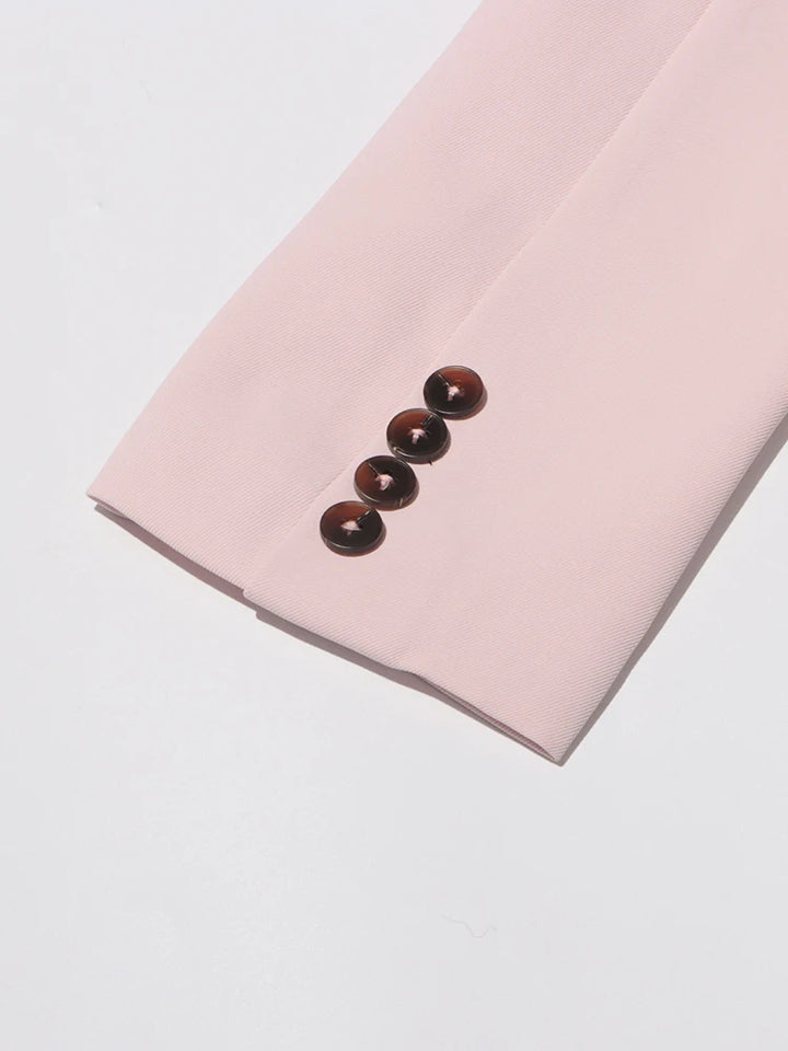 Pink slim blazer sleeve cuff with three dark button accents
