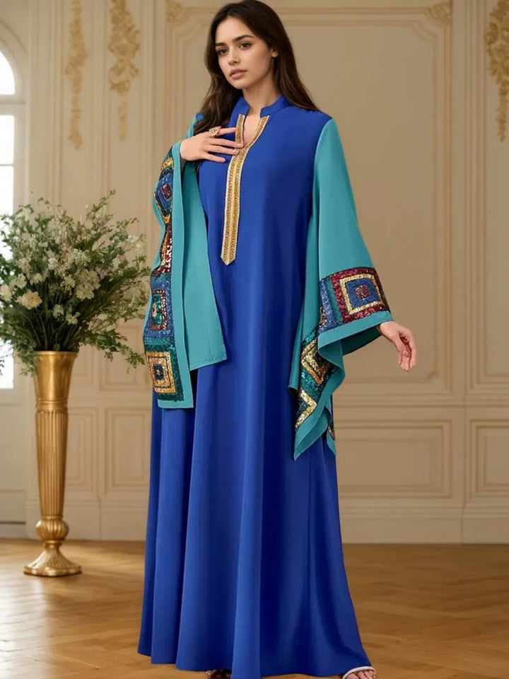 Blue long dress with batwing sleeves and turquoise side panels, gold tassel trim at neck