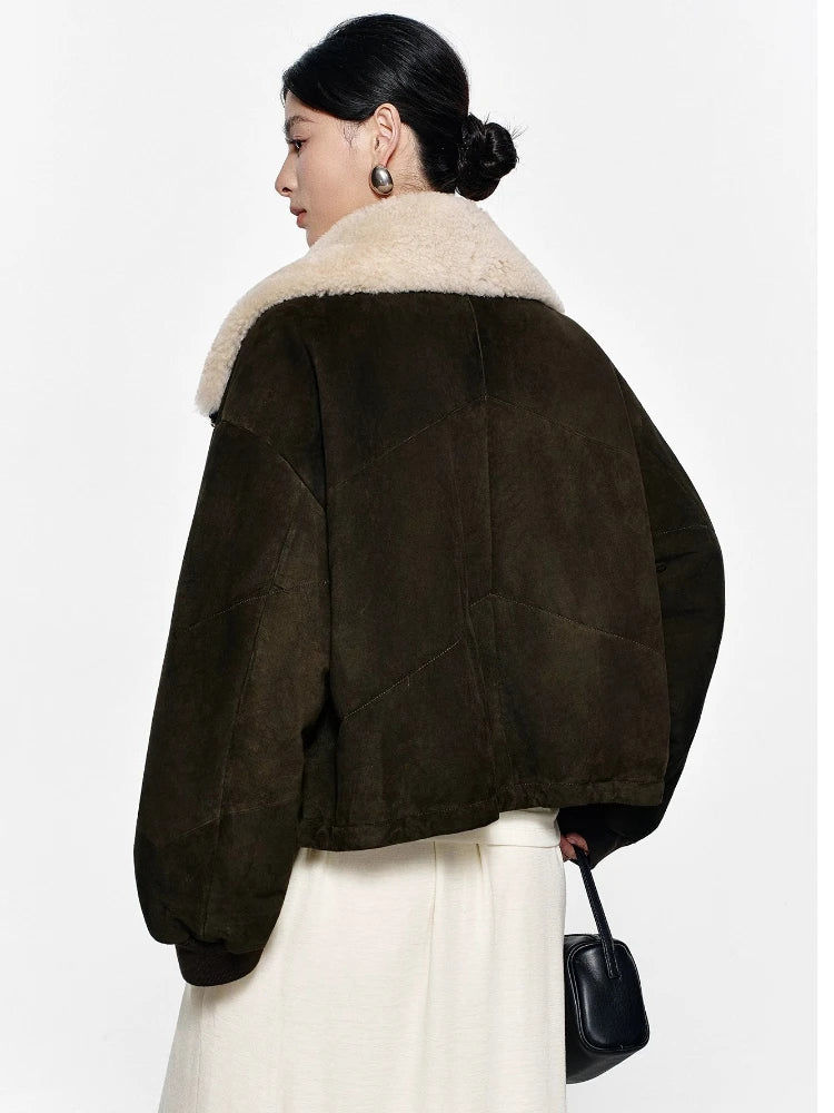 Dark olive suede coat with cream shearling-lined back collar and relaxed sleeves