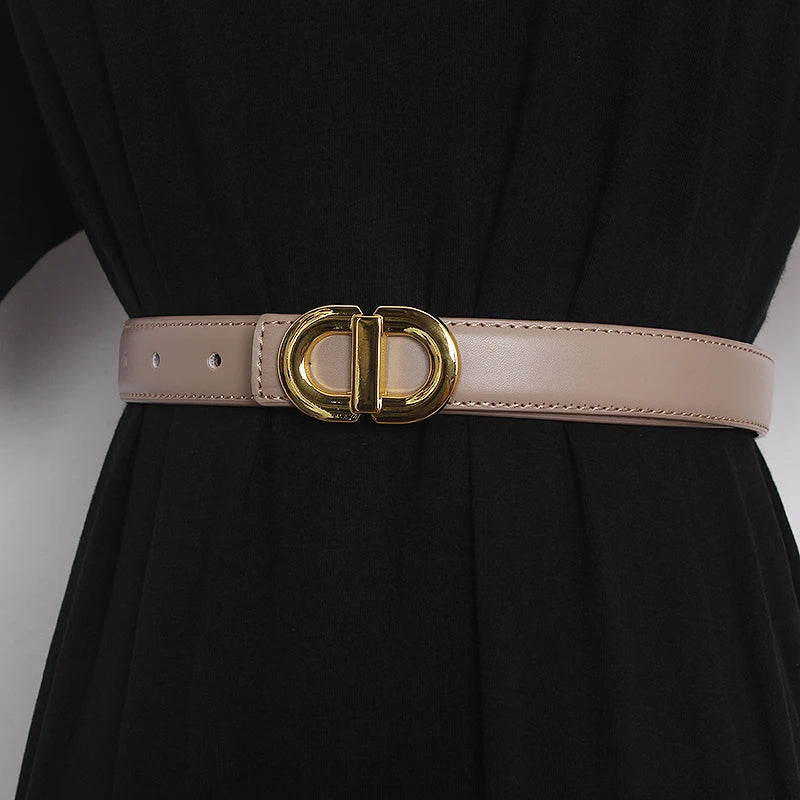Light pink narrow leather waist belt with gold-tone double D buckle and adjustment holes