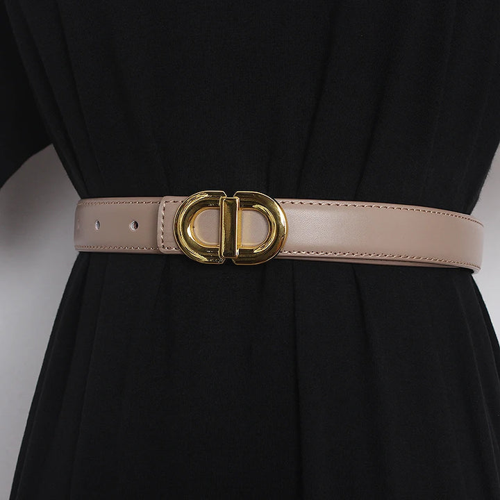 Light pink narrow leather waist belt with gold-tone double D buckle and adjustment holes