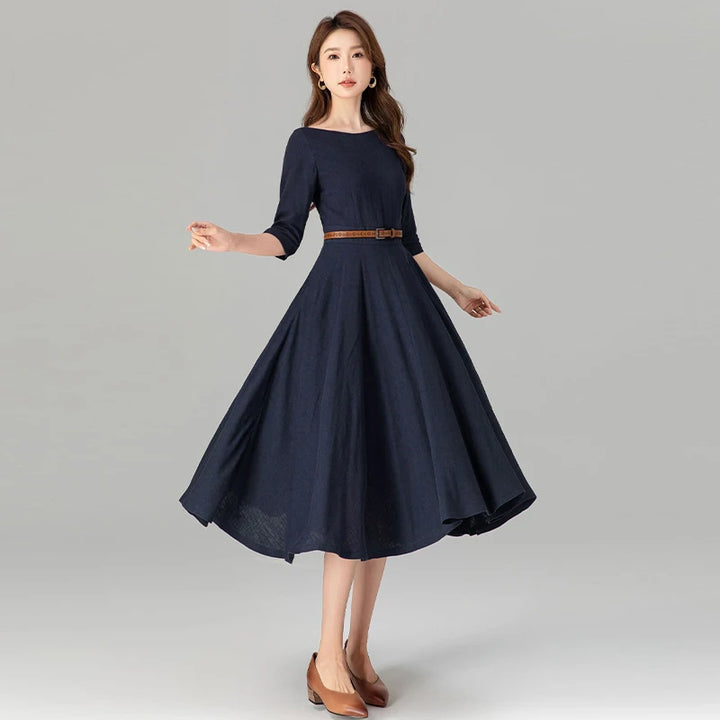 Dark blue midi dress with quarter sleeves, gathered waist, and full pleated skirt