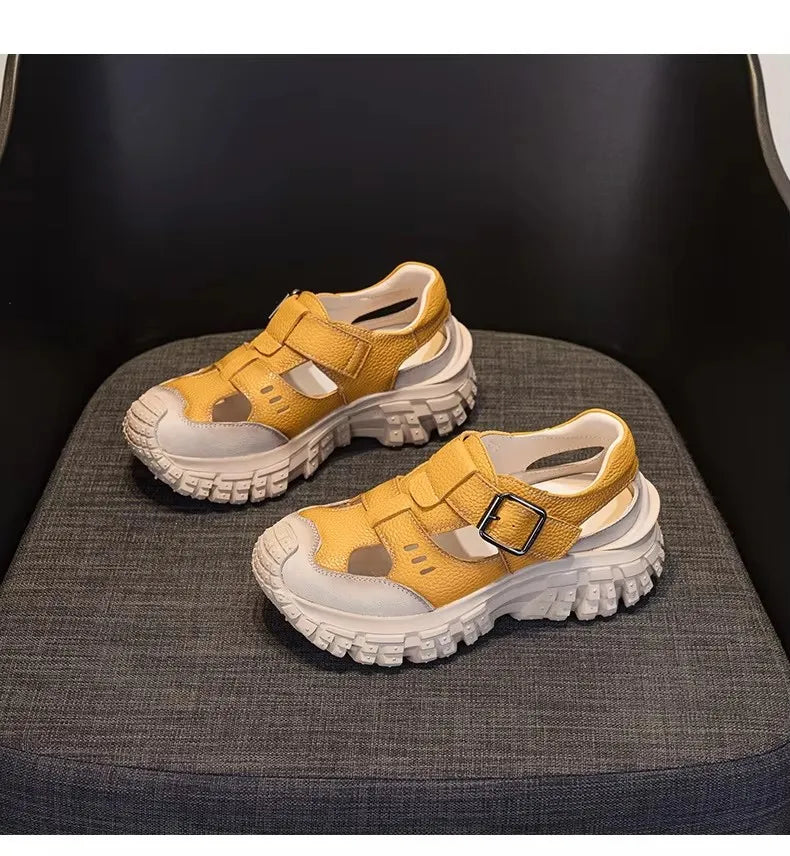 Pair of yellow leather chunky sandals with thick tread and adjustable straps