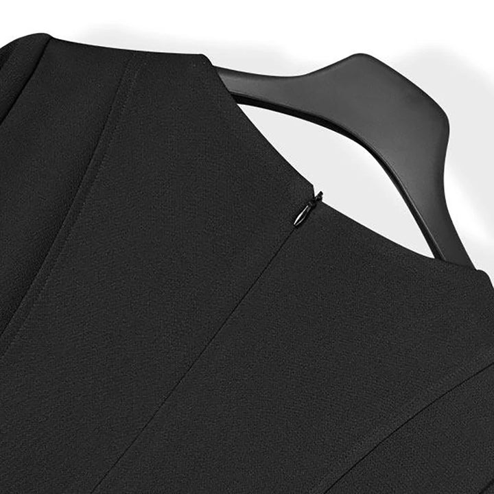 Black V-neck dress close-up with small keyhole opening at neckline