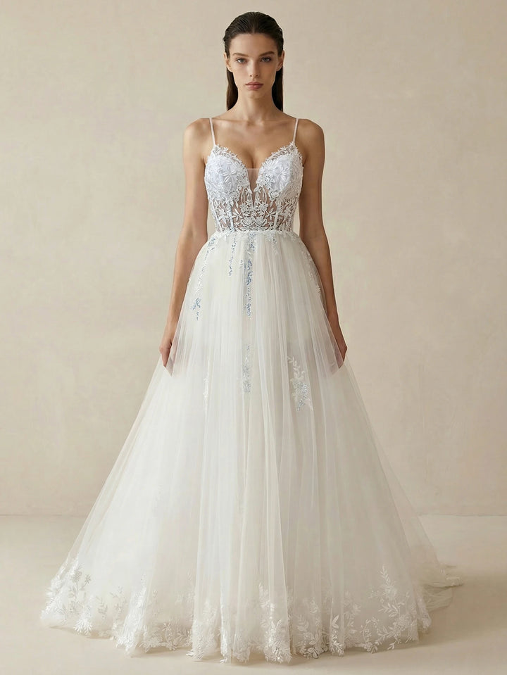 White tulle bridal gown with deep V lace bodice, thin straps, and full A-line skirt