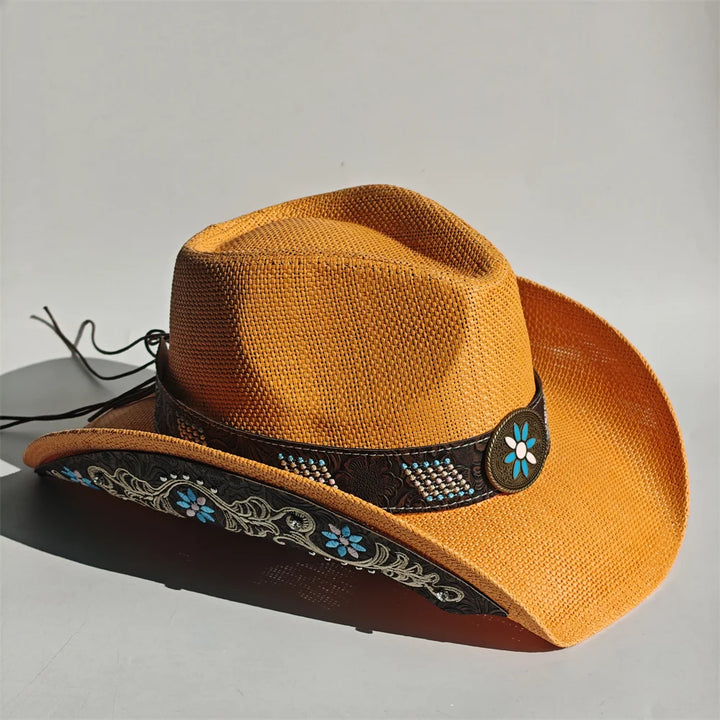 Tan cowboy hat with dark hatband, teal floral embroidery, and flower badge