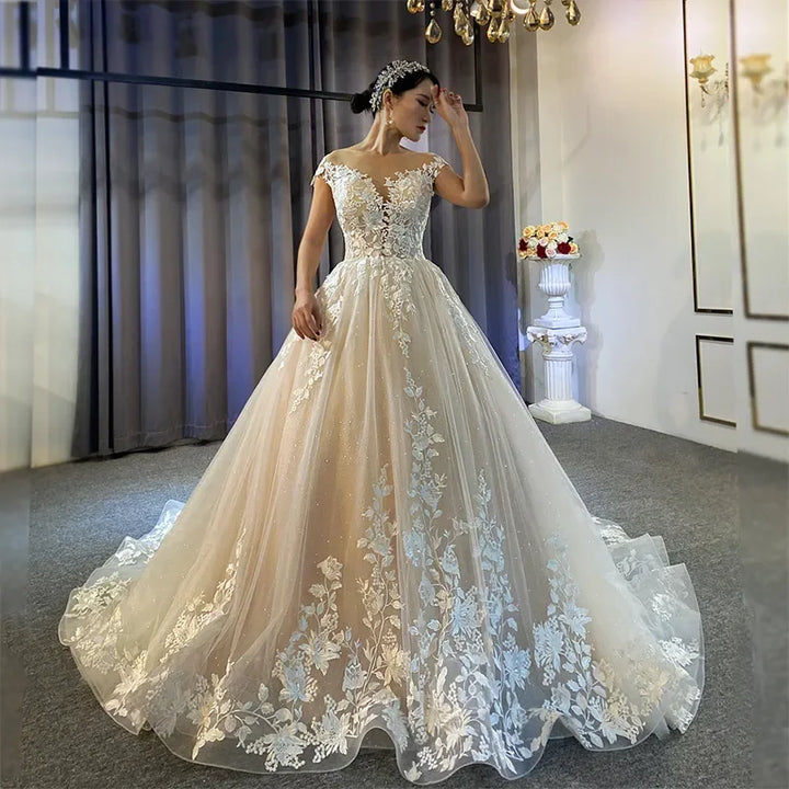 Woman wearing a white lace wedding dress in an elegant room.