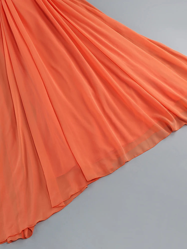 Orange A-line dress with layered ruffle pleats and flared hem
