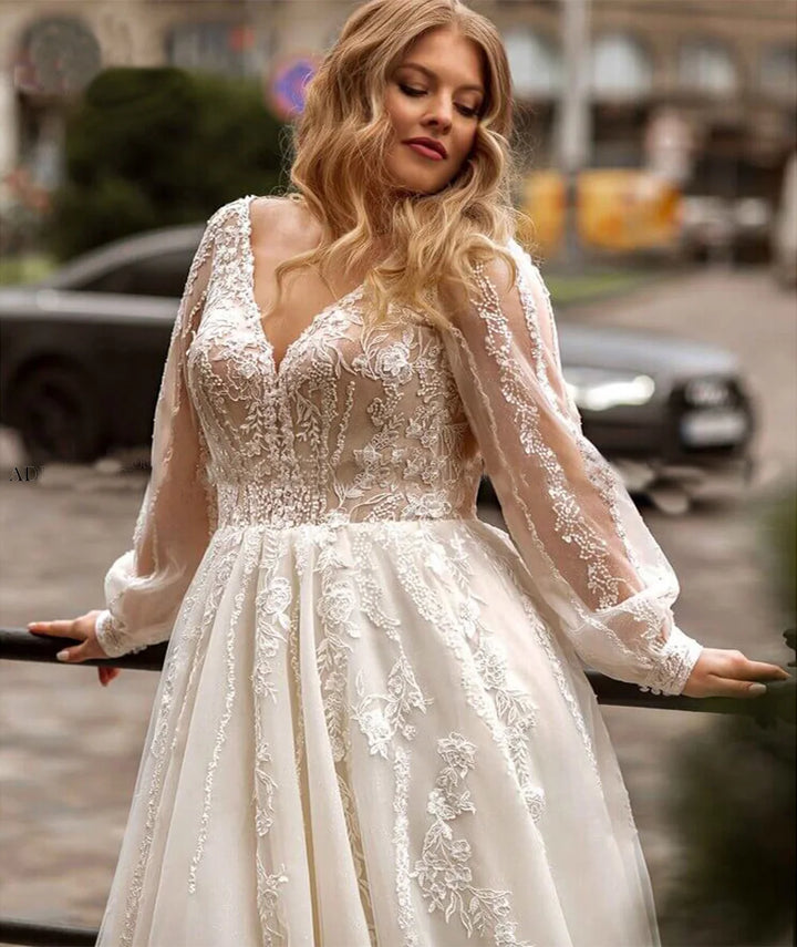 Plus size bridal gown in sheer long sleeves with lace bodice and tulle skirt, ivory