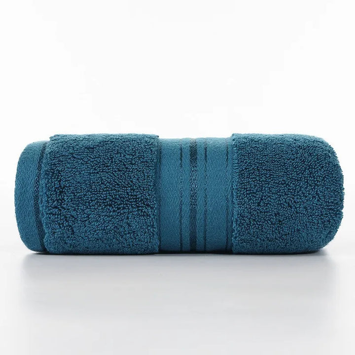 Teal blue face towel roll with stitched stripe bands and dense plush looped fabric